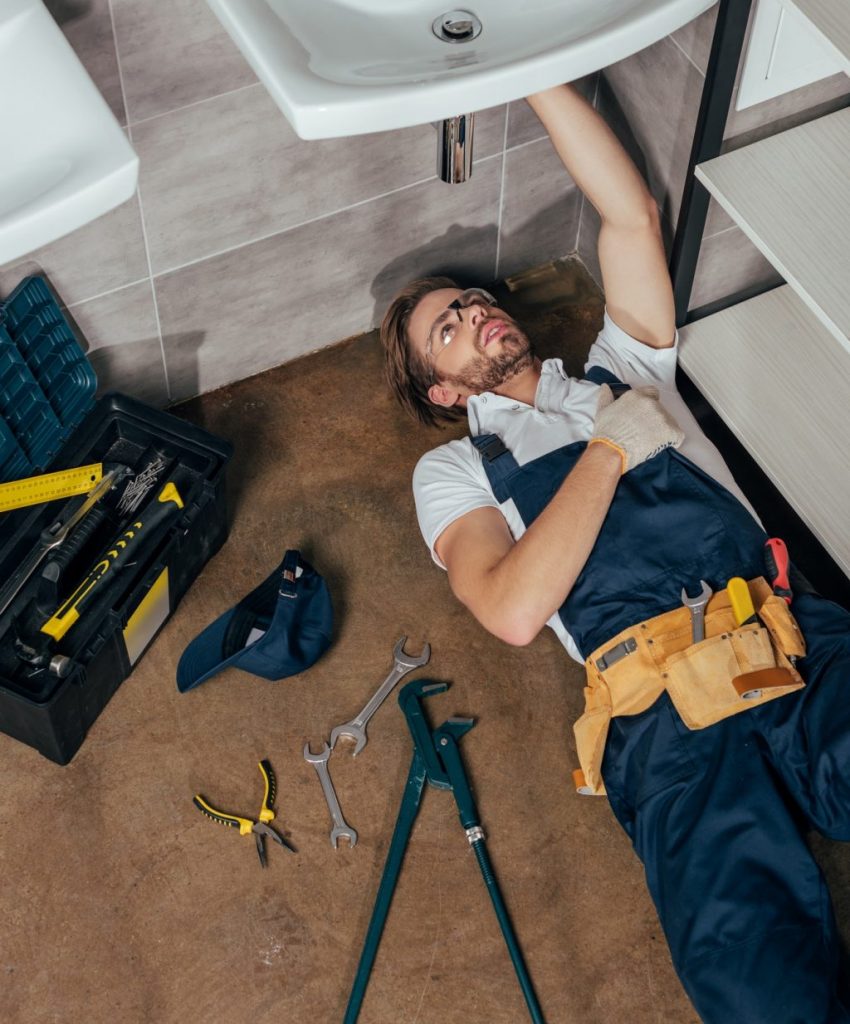 high-angle-view-of-young-male-plumber-fixing-sink-in-bathroom-e1621305605808-p7c9i3evnvf6uv2jbmc4hw2h58ui7fanees551ffcw